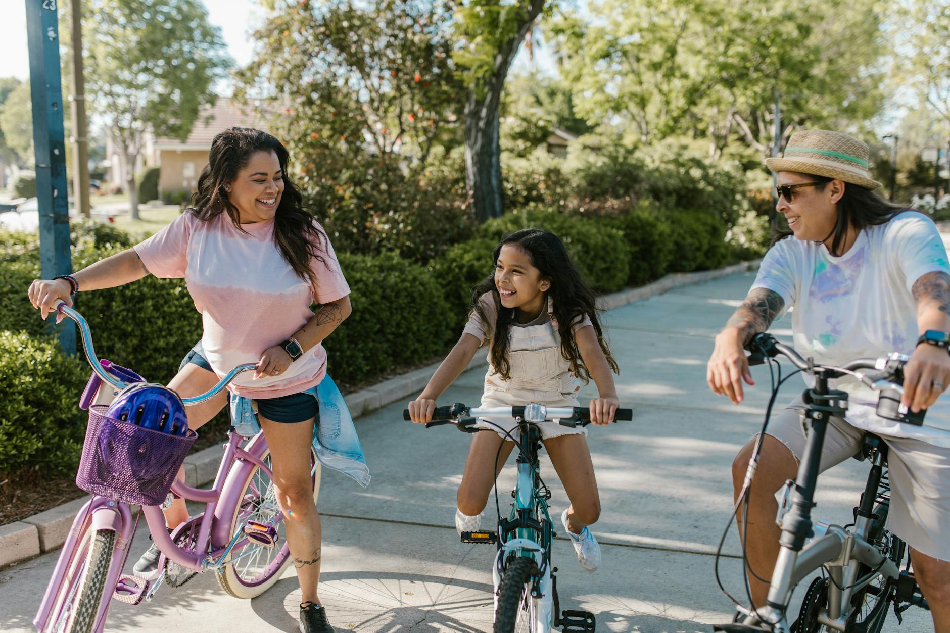 Happy family enjoying a leisurely bike ride in a sunny park, showcasing bonding and togetherness.